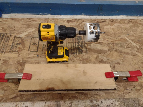 Scrap wood clamped together on work bench. 